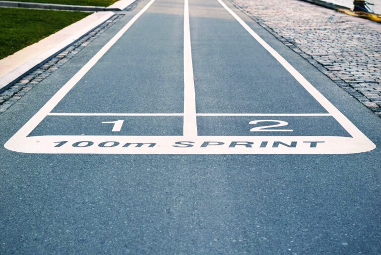 Is a running coach worth it? Image of the start of a 100m sprint track